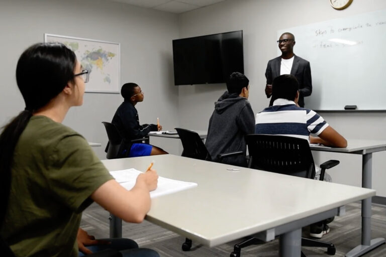 PrepWithMo | Students watching SAT/ACT coach and college admissions counselor, Mo, at the board during college test prep class